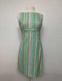 This is a striped mini dress with a high cut neckline and hits at the knee. The vertical striped pattern is mainly green with hints of blue and pink. There is a horizontal green stripe at the bust line. 